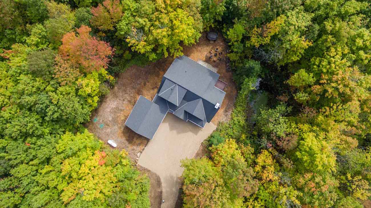 Top down view of home nestled into forest
