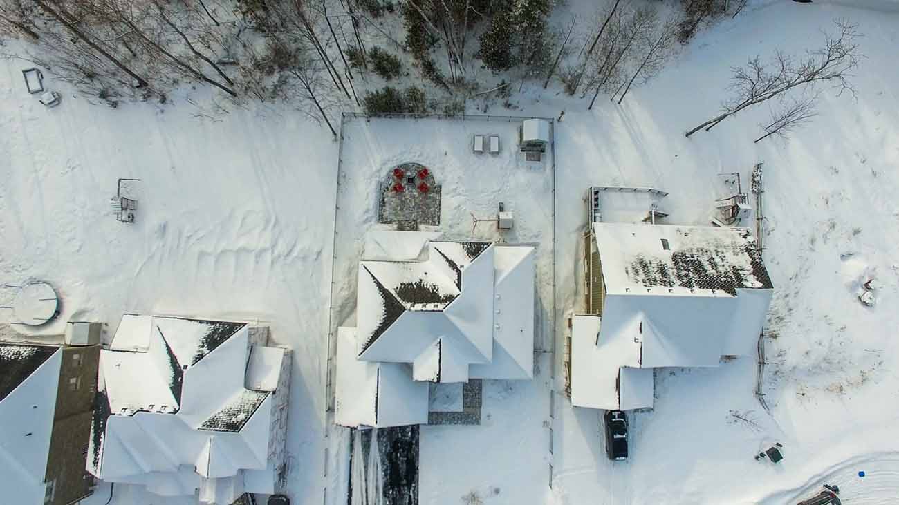 Top down view of a house in winter covered in snow